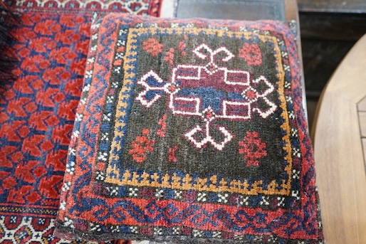Two Caucasian cushions, larger 67 x 45cm together with a bag face